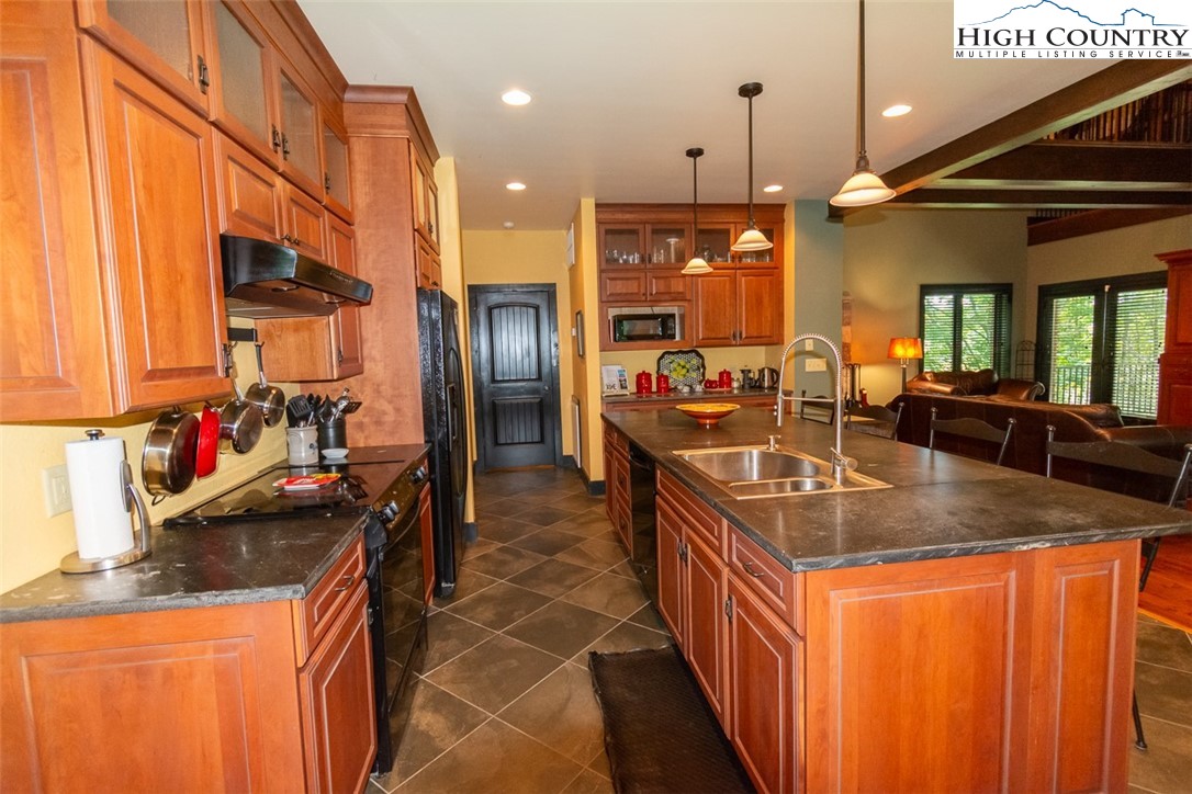 572 Stonegate Lane Creston, NC 28615 - Photo 13 of 48 a kitchen with stainless steel appliances granite countertop a sink a counter space and a refrigerator