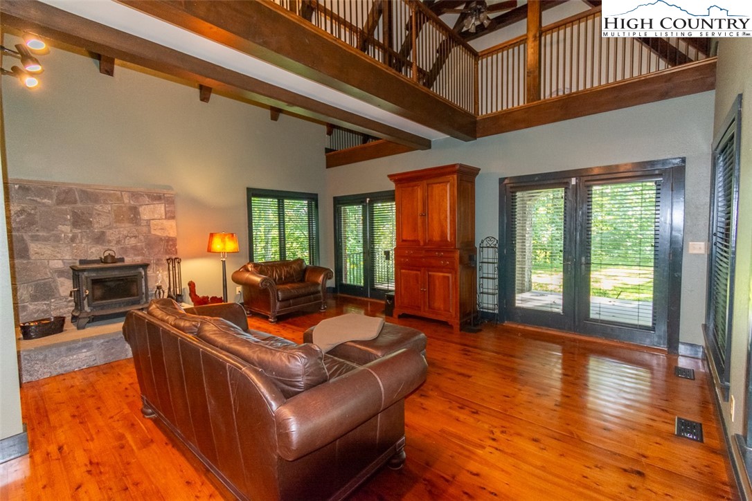 572 Stonegate Lane Creston, NC 28615 - Photo 18 of 48 a living room with furniture floor to ceiling window and wooden floor
