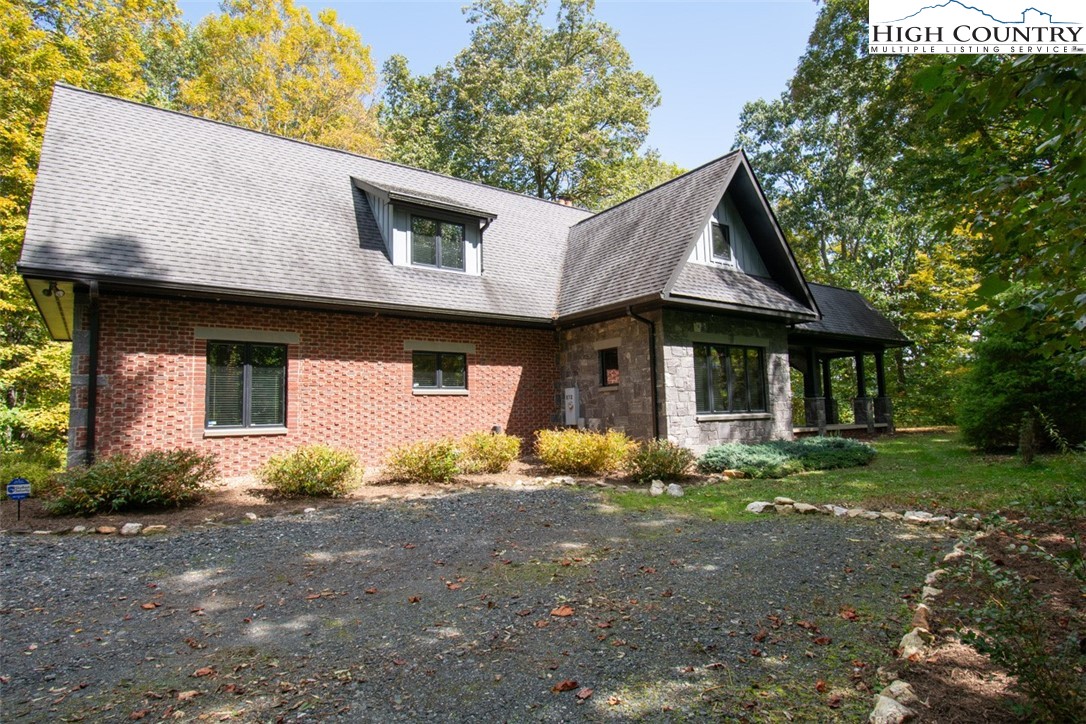 572 Stonegate Lane Creston, NC 28615 - Photo 2 of 48 a front view of a house with garden
