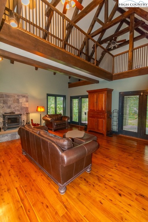 572 Stonegate Lane Creston, NC 28615 - Photo 23 of 48 a living room with furniture a fireplace and a chandelier