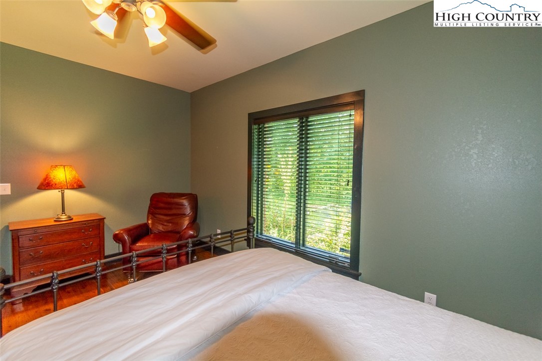 572 Stonegate Lane Creston, NC 28615 - Photo 25 of 48 a bedroom with furniture and lamp on dresser