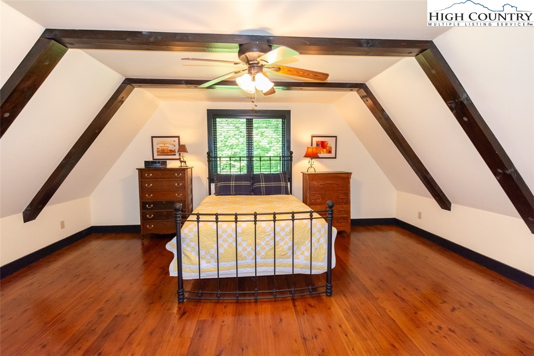 572 Stonegate Lane Creston, NC 28615 - Photo 33 of 48 a bedroom with a bed and wooden floor