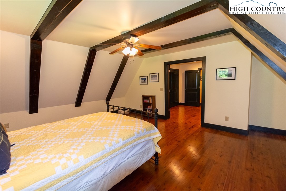 572 Stonegate Lane Creston, NC 28615 - Photo 34 of 48 a bedroom with bed and wooden floor