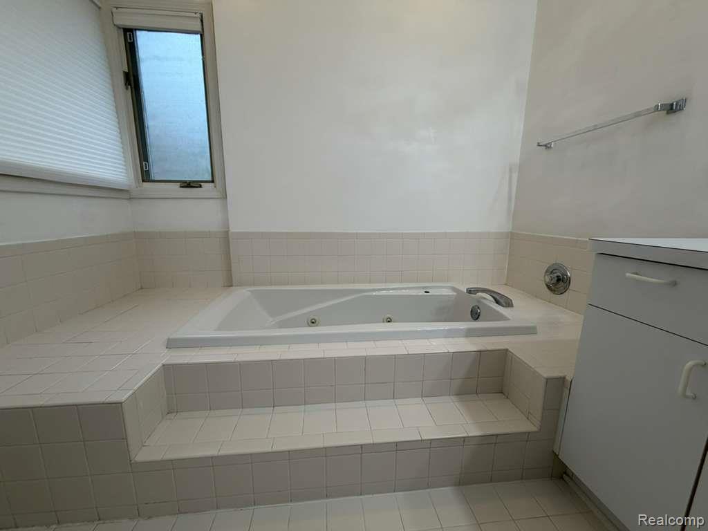 1154 Bluebird Drive Rochester, MI 48307 - Photo 24 of 34 Built-in jetted tub surrounded by white ceramic tile