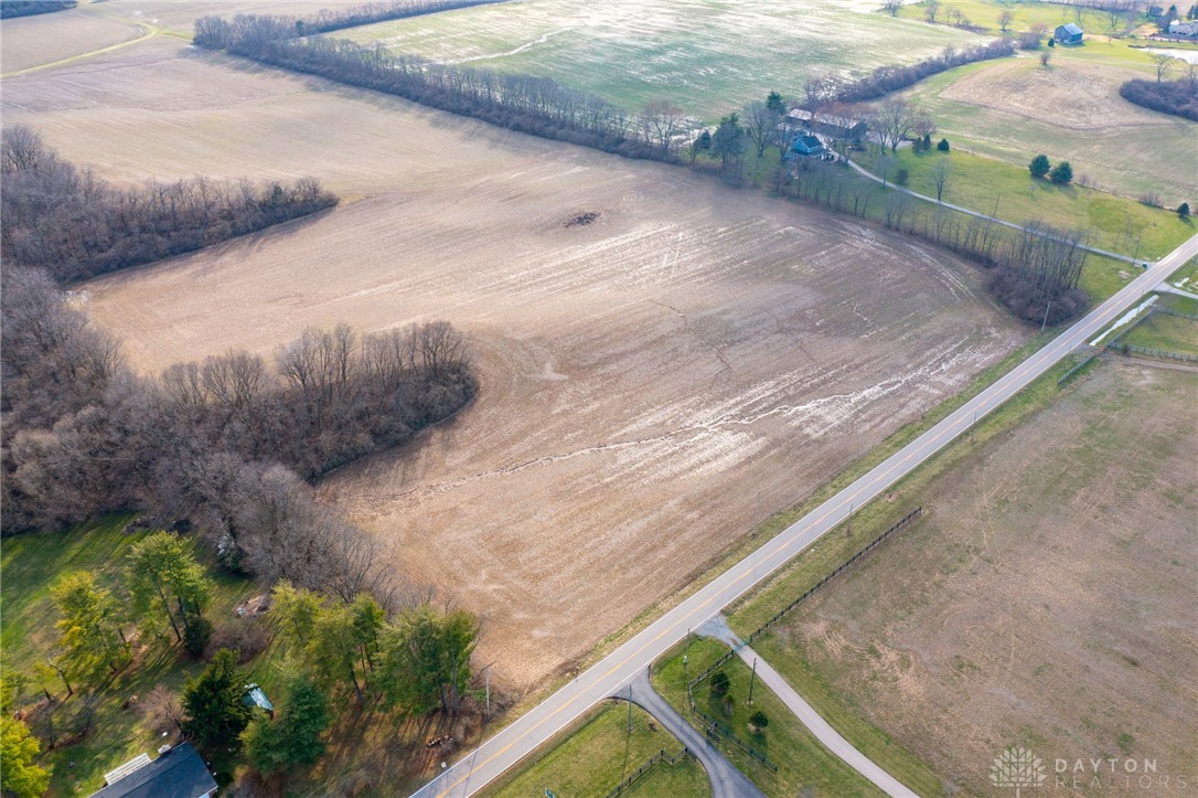 Lot 2 Lot Road Springboro, OH 45066 - Photo 4 of 14 An aerial perspective reveals vast fields bordered by natural tree lines and a tranquil road.