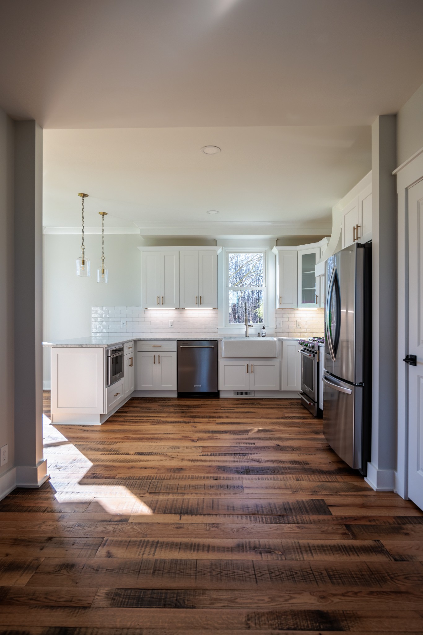7776 Lampley Road Primm Springs, TN 38476 - Photo 16 of 50 a view of a kitchen with wooden floor and electronic appliances