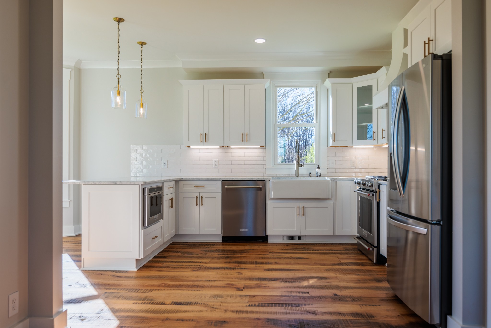 7776 Lampley Road Primm Springs, TN 38476 - Photo 17 of 50 a kitchen with a sink stainless steel appliances and cabinets