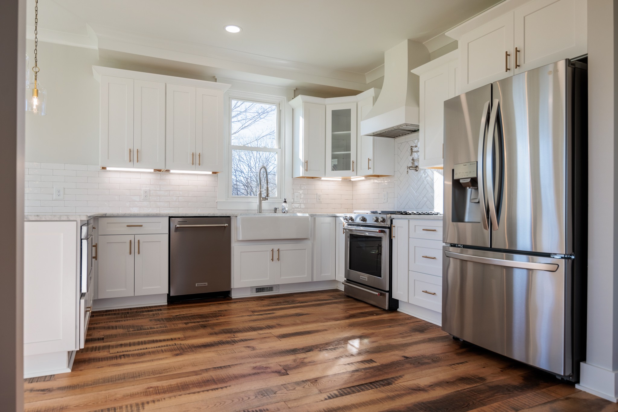 7776 Lampley Road Primm Springs, TN 38476 - Photo 18 of 50 a kitchen with a refrigerator sink and wooden floor