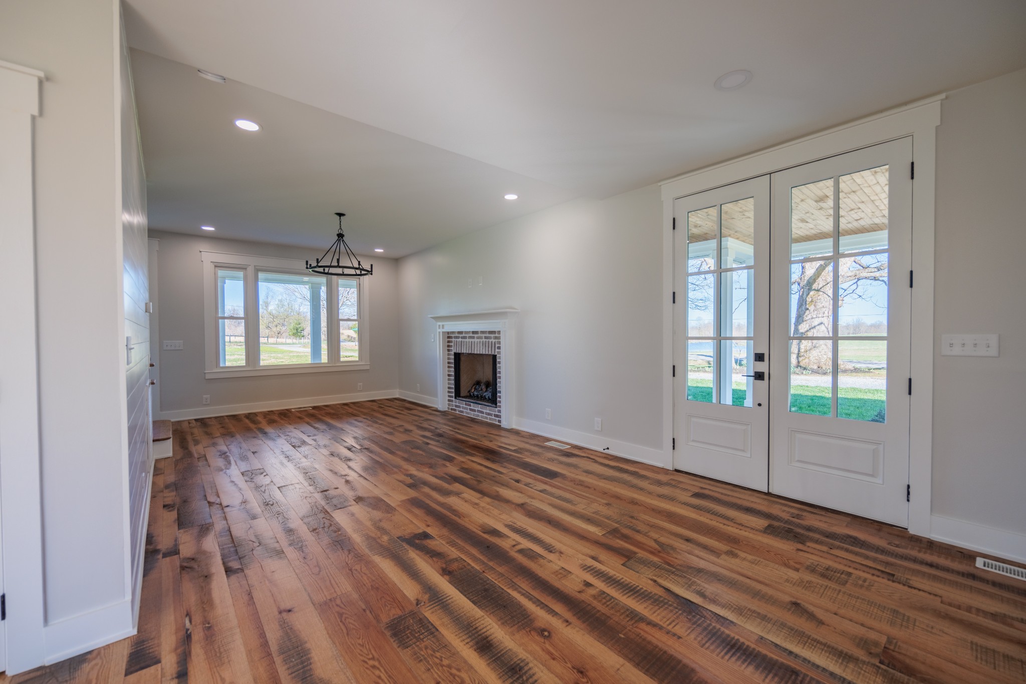 7776 Lampley Road Primm Springs, TN 38476 - Photo 21 of 50 a view of an empty room with wooden floor and a window