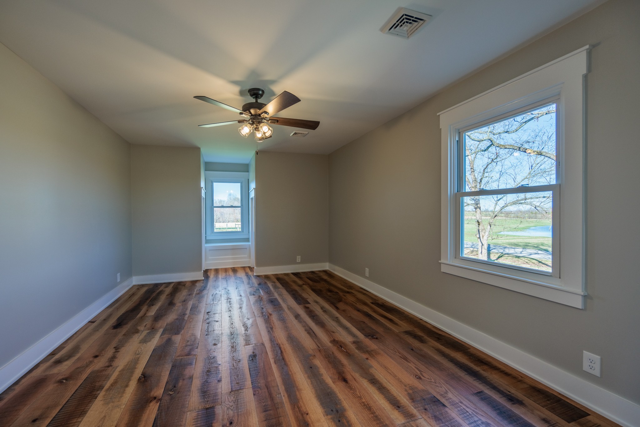 7776 Lampley Road Primm Springs, TN 38476 - Photo 34 of 50 wooden floor in an empty room with a window