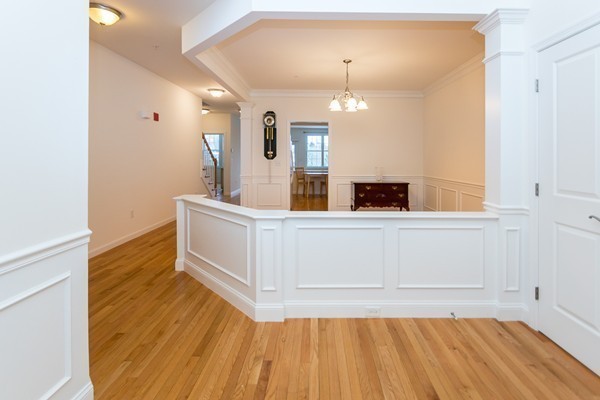 16 Bartlett Way, Unit 3 Waltham, MA 02452 - Photo 12 of 30 a view of a room with wooden floor and staircase