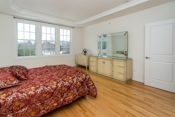 16 Bartlett Way, Unit 3 Waltham, MA 02452 - Photo 16 of 30 a bedroom with a bed and large windows