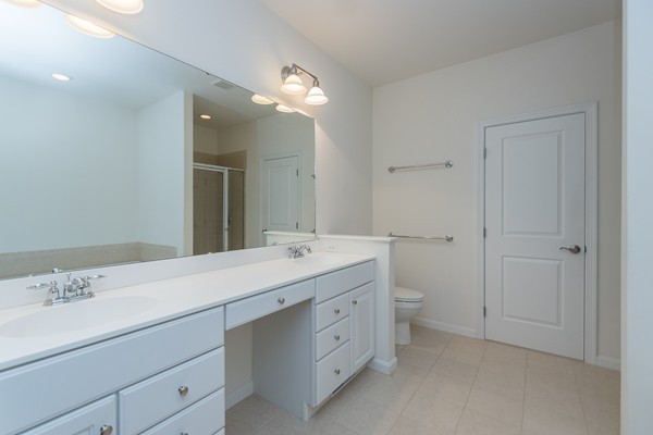 16 Bartlett Way, Unit 3 Waltham, MA 02452 - Photo 19 of 30 a spacious bathroom with a double vanity sink mirror and toilet
