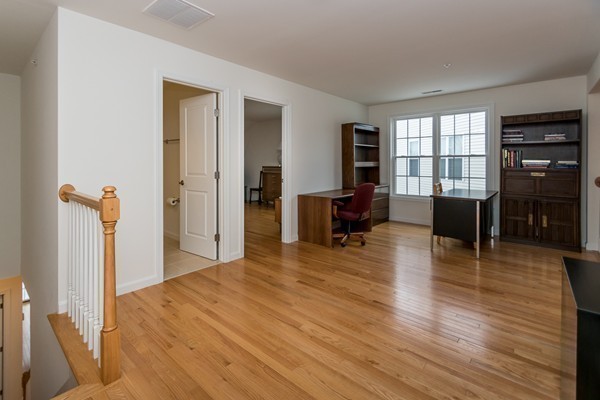 16 Bartlett Way, Unit 3 Waltham, MA 02452 - Photo 20 of 30 a living room with furniture and a wooden floor