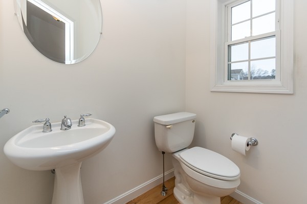 16 Bartlett Way, Unit 3 Waltham, MA 02452 - Photo 25 of 30 a bathroom with a toilet a sink and a mirror