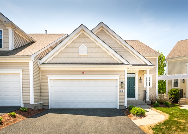 16 Bartlett Way, Unit 3 Waltham, MA 02452 - Photo 4 of 30 a front view of a house with a yard and garage