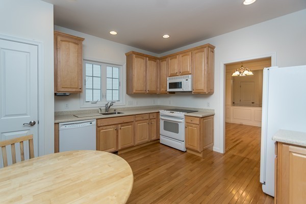 16 Bartlett Way, Unit 3 Waltham, MA 02452 - Photo 6 of 30 a kitchen with a sink cabinets appliances and wooden floor