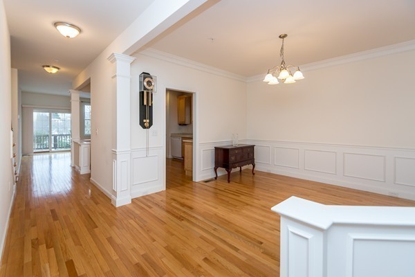 16 Bartlett Way, Unit 3 Waltham, MA 02452 - Photo 9 of 30 a view of a room with wooden floor table and chairs