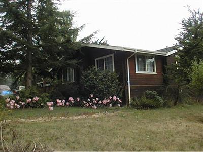 61 Cypress Road Point Reyes Station, CA 94956 - Photo 3 of 6 a front view of a house with a garden