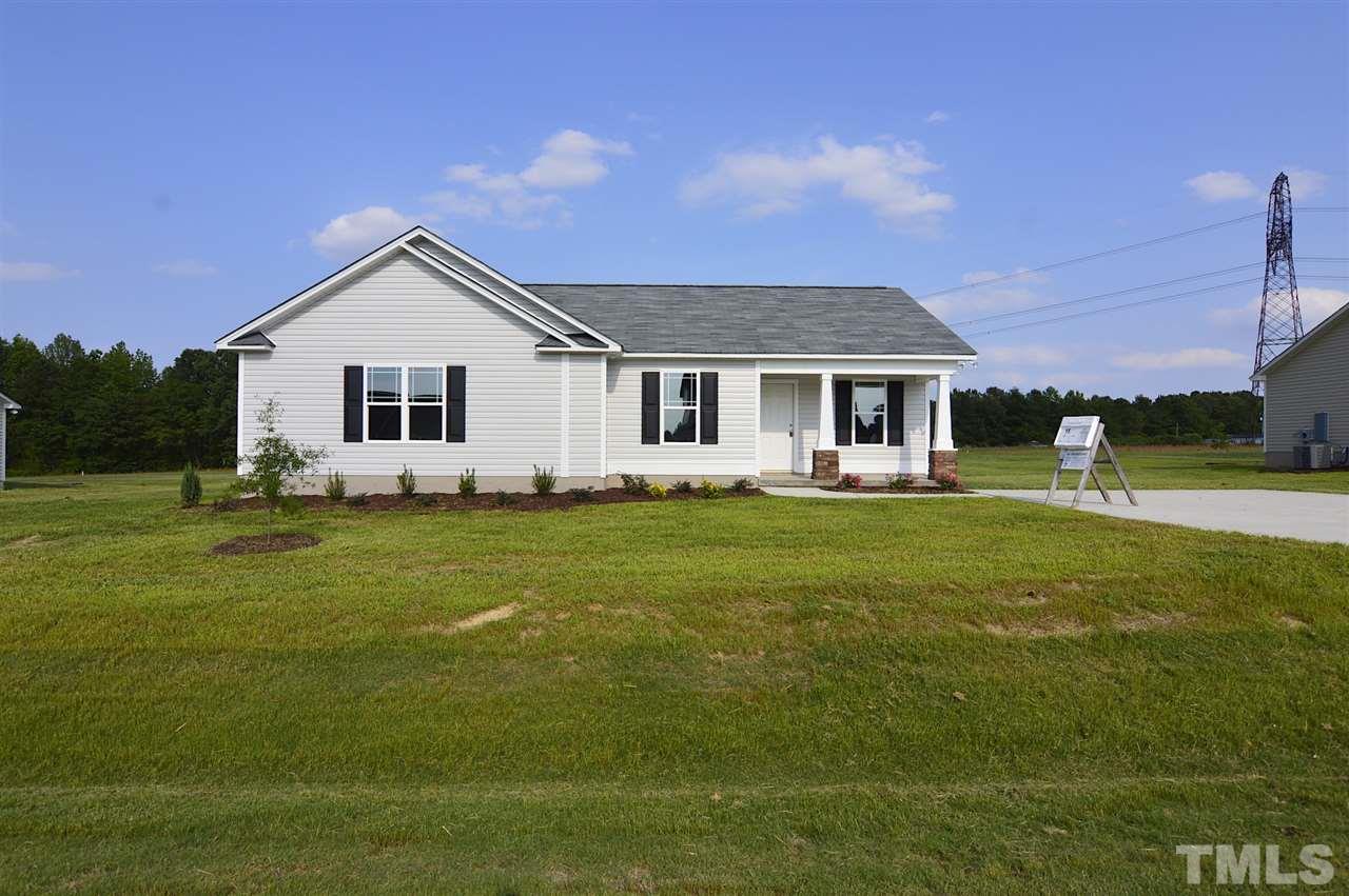 92 Willow Ridge Circle Willow Spring, NC 27592 - Photo 1 of 16 a front view of a house with a garden