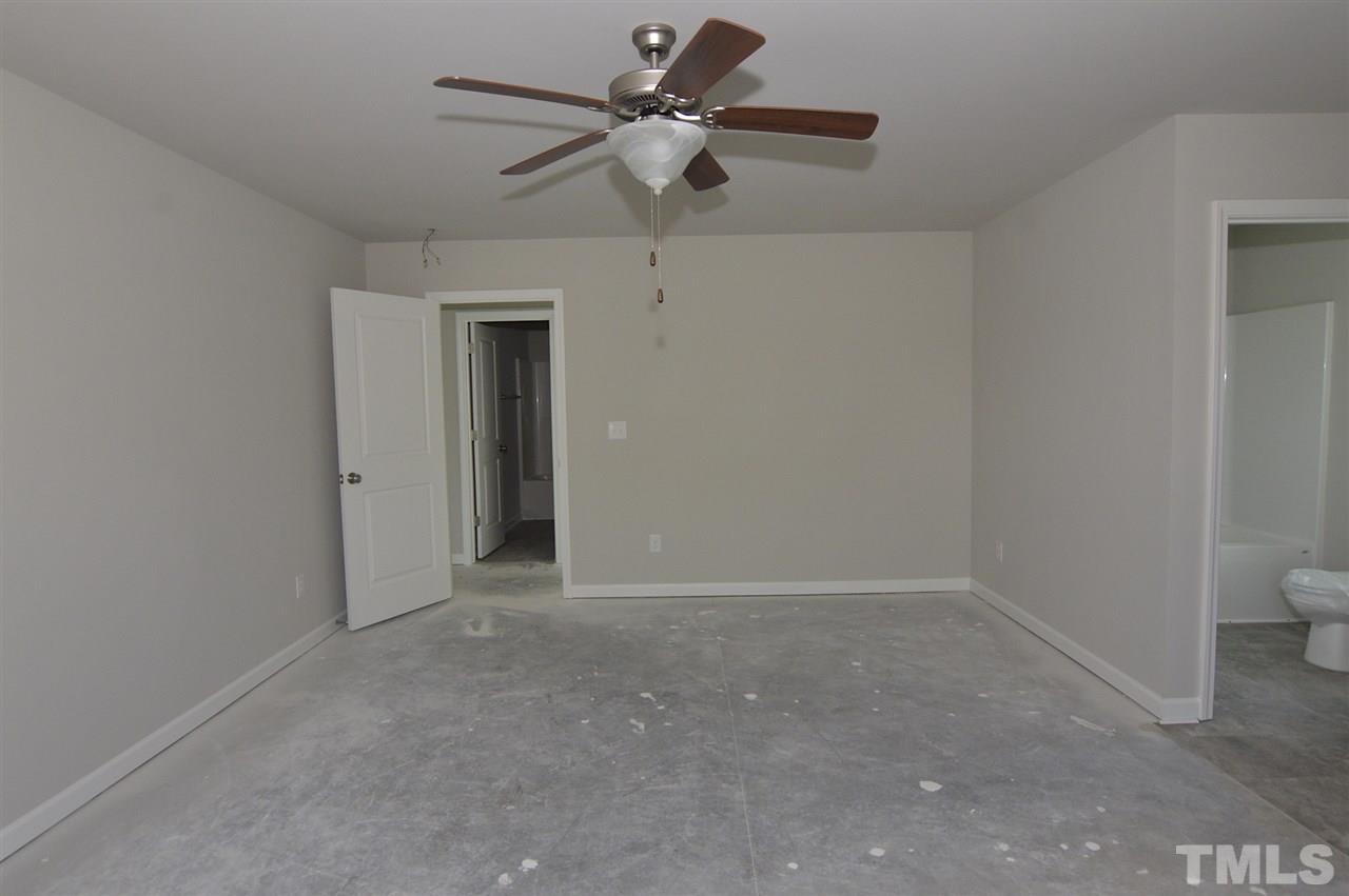 92 Willow Ridge Circle Willow Spring, NC 27592 - Photo 11 of 16 a view of a room with a fan