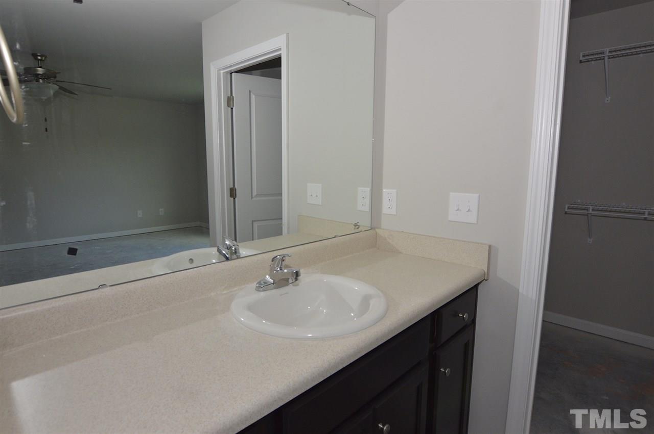 92 Willow Ridge Circle Willow Spring, NC 27592 - Photo 12 of 16 a bathroom with a sink and a mirror