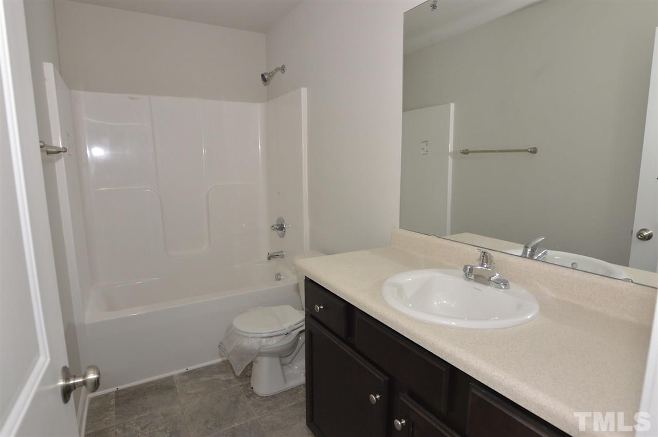 92 Willow Ridge Circle Willow Spring, NC 27592 - Photo 15 of 16 a bathroom with a sink a toilet and shower