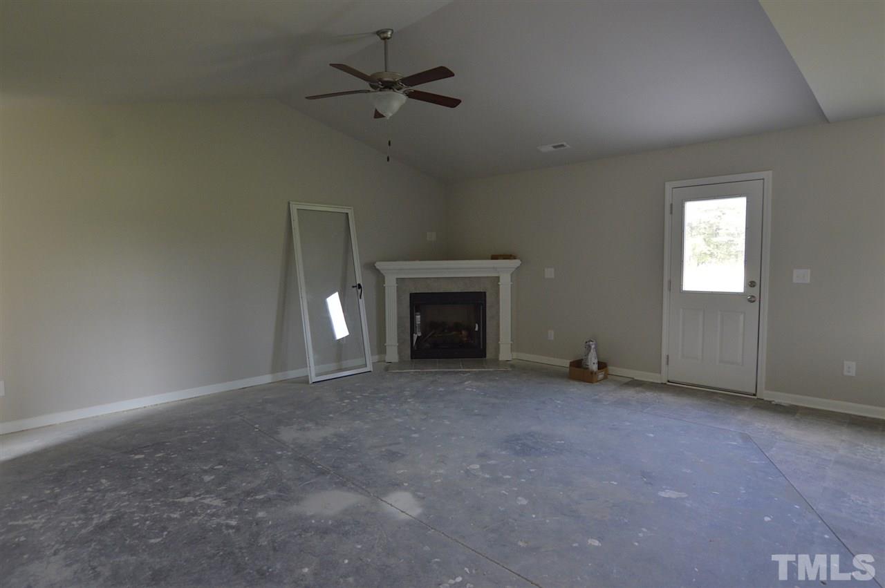 92 Willow Ridge Circle Willow Spring, NC 27592 - Photo 3 of 16 a view of an empty room with a fireplace