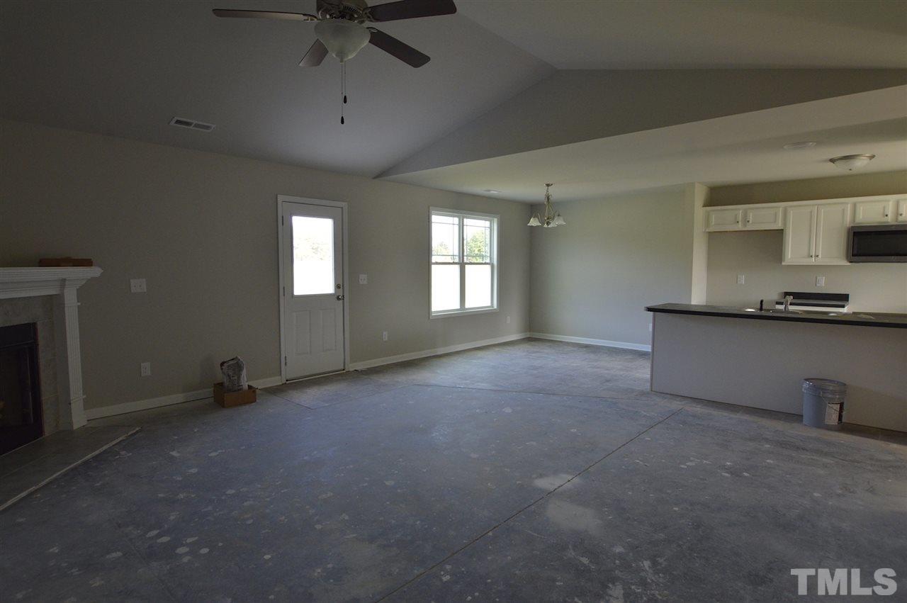 92 Willow Ridge Circle Willow Spring, NC 27592 - Photo 4 of 16 a view of an empty room and a window