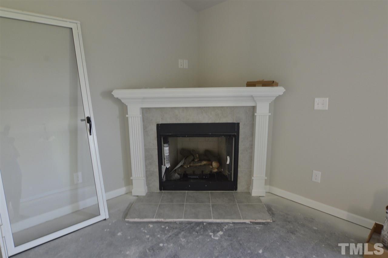 92 Willow Ridge Circle Willow Spring, NC 27592 - Photo 5 of 16 a living room with a fireplace