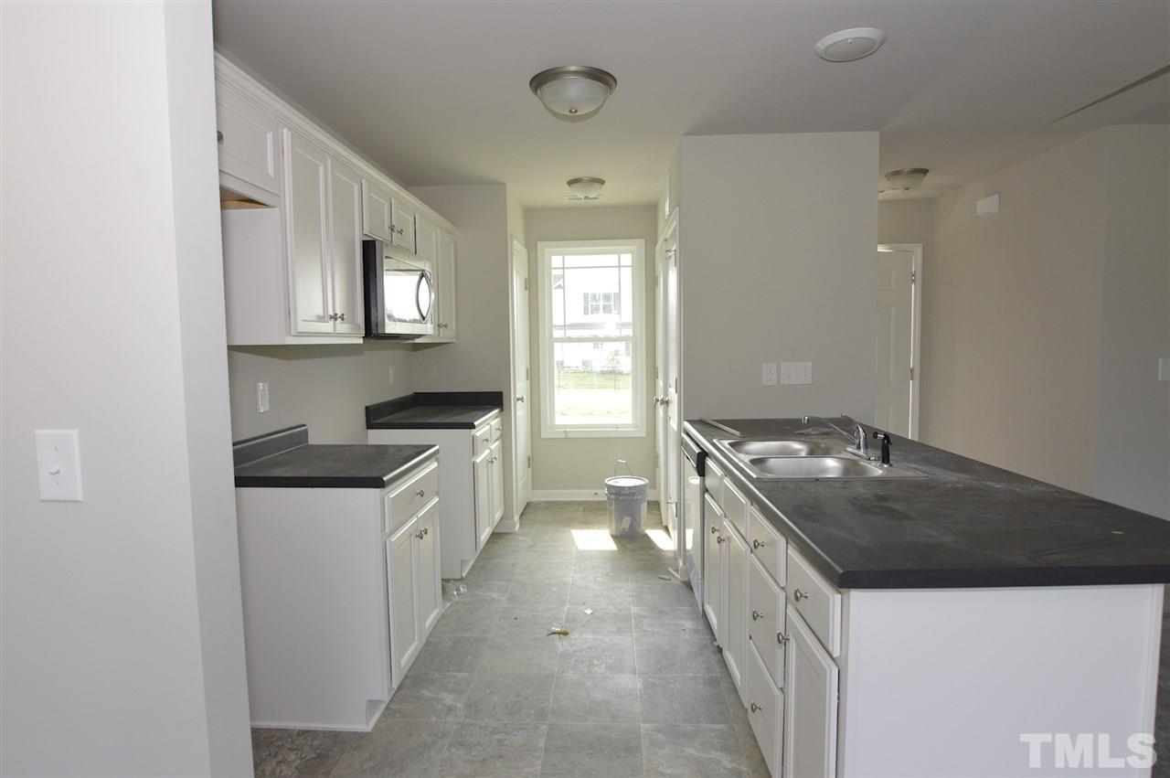 92 Willow Ridge Circle Willow Spring, NC 27592 - Photo 6 of 16 a kitchen with a stove and a sink