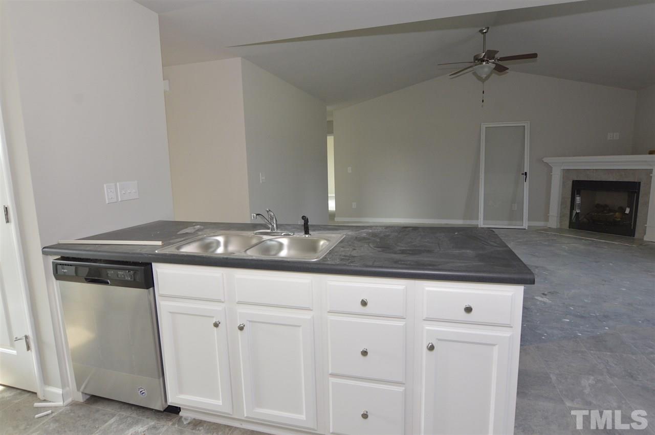 92 Willow Ridge Circle Willow Spring, NC 27592 - Photo 8 of 16 a kitchen with granite countertop a sink cabinets and stainless steel appliances