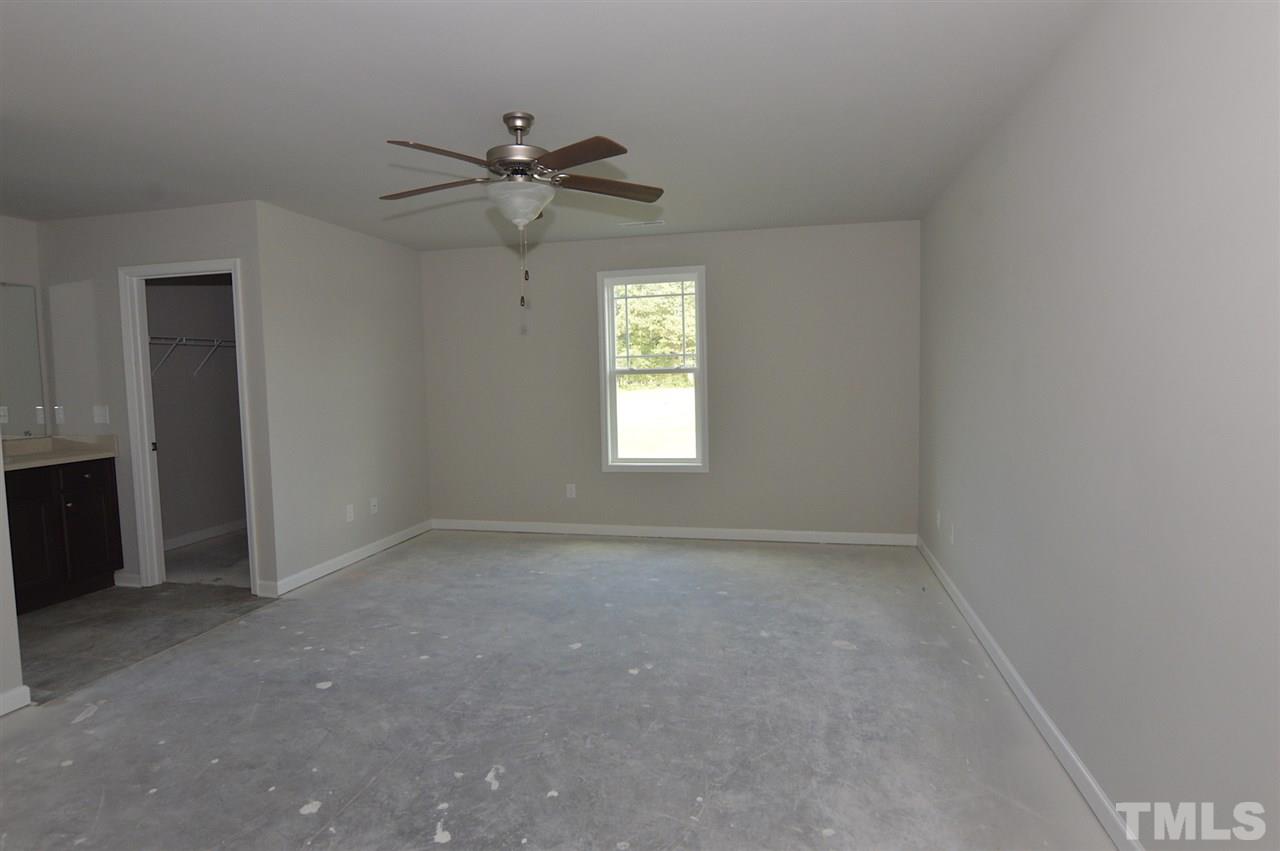 92 Willow Ridge Circle Willow Spring, NC 27592 - Photo 10 of 16 a view of an empty room with a window