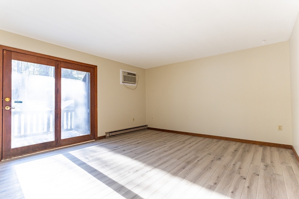 38 Drake Road, Unit 38 Fitchburg, MA 01420 - Photo 13 of 31 an empty room with wooden floor and windows