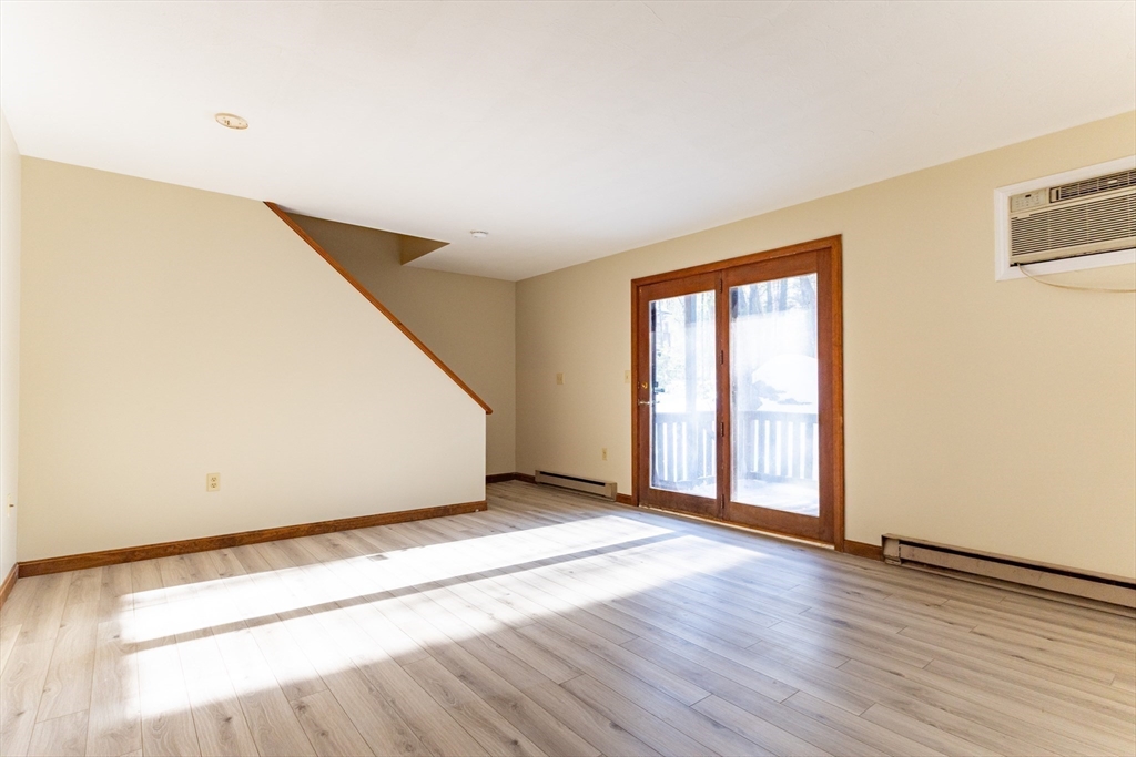 38 Drake Road, Unit 38 Fitchburg, MA 01420 - Photo 3 of 31 an empty room with wooden floor and windows