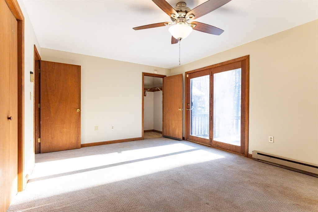 38 Drake Road, Unit 38 Fitchburg, MA 01420 - Photo 4 of 31 an empty room with chandelier fan and windows