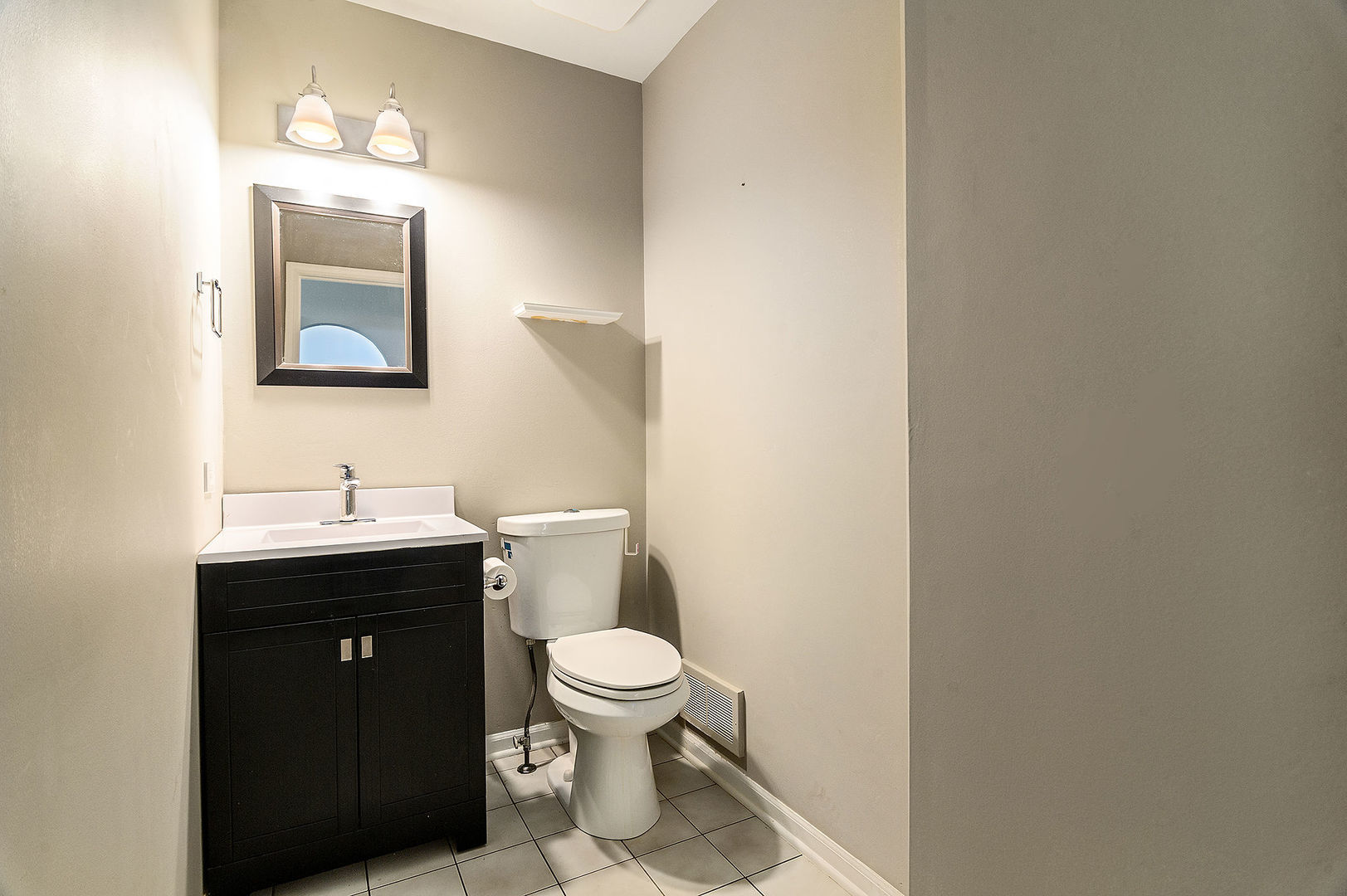 1516 Diamond Drive Hoffman Estates, IL 60192 - Photo 8 of 20 a bathroom with a toilet sink vanity and mirror