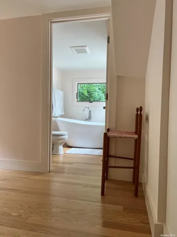 a view of a room that has a bed and a window