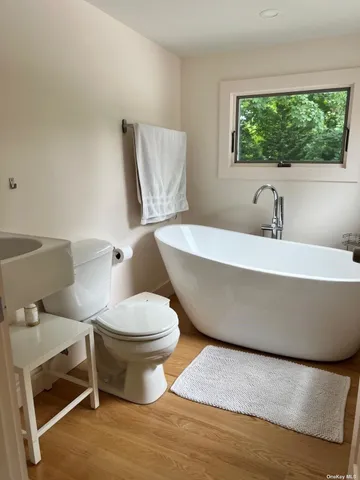 a white toilet sitting next to a window