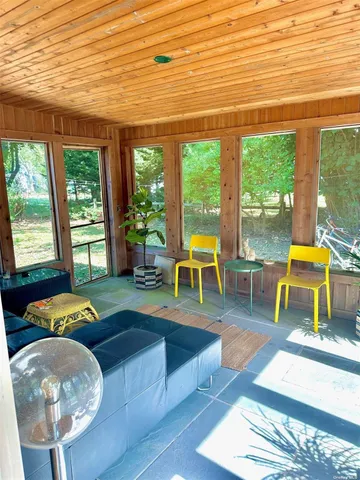 a living room with furniture and a floor to ceiling window