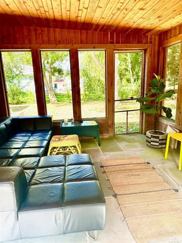 a room with pool table and windows