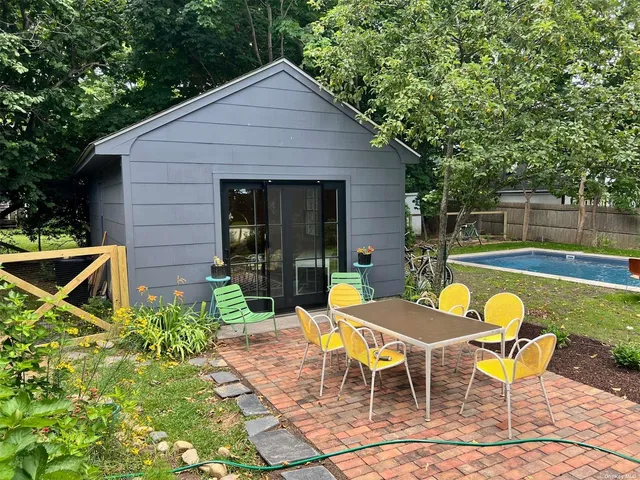 a view of a chairs and table in the backyard