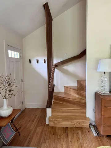 a view of entryway and hall with wooden floor