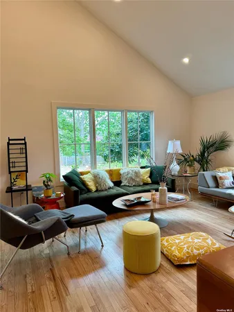 a living room with furniture and floor to ceiling windows