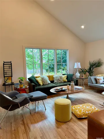 a living room with furniture and floor to ceiling windows