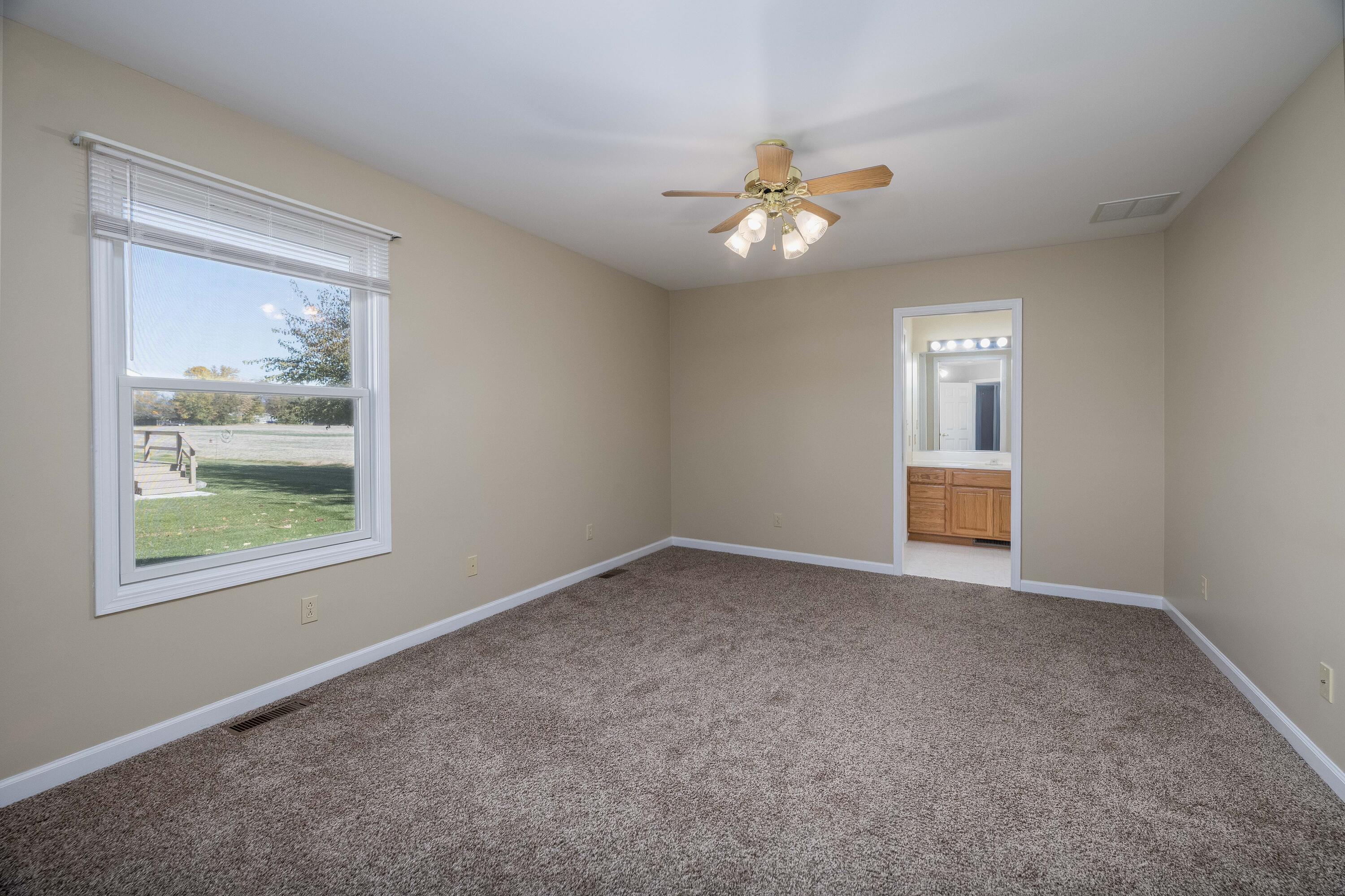 431 Pheasant Run Rensselaer, IN 47978 - Photo 22 of 31 an empty room with windows and ceiling fan