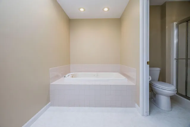 a bathroom with a bathtub and toilet