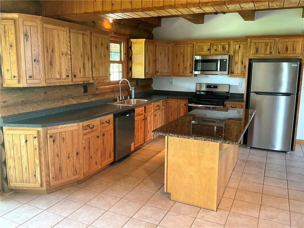 140 Hauger Road Rockwood, PA 15557 - Photo 17 of 50 a kitchen with stainless steel appliances granite countertop a stove a sink and a microwave