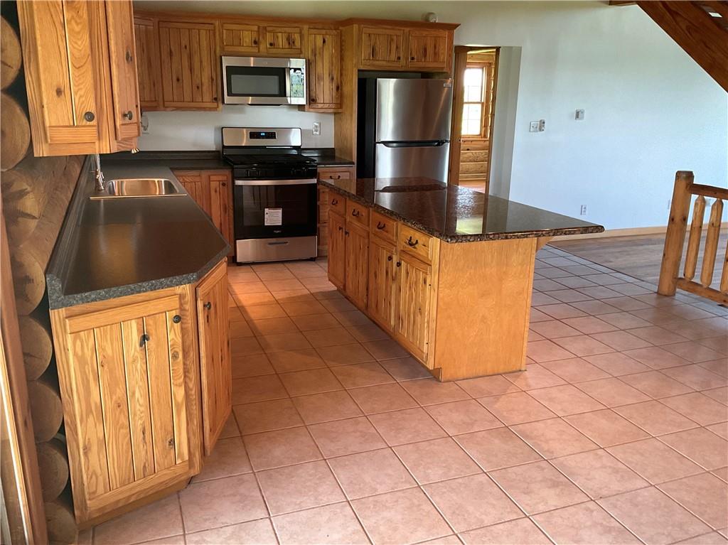 140 Hauger Road Rockwood, PA 15557 - Photo 18 of 50 a kitchen with granite countertop a refrigerator and a stove top oven