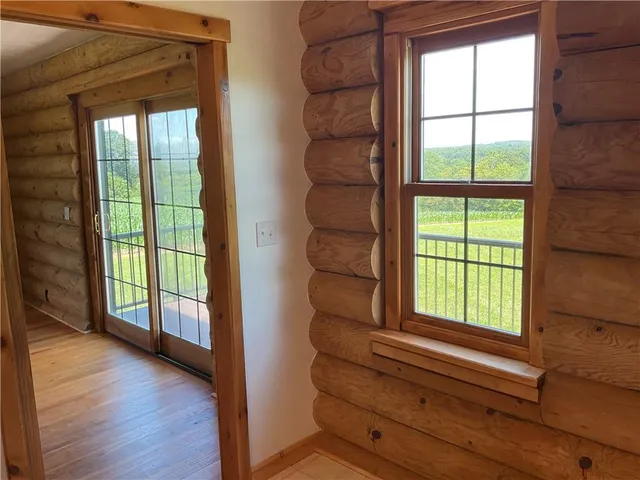 a view of room with window and a ceiling fan